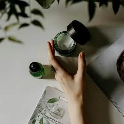 Hands applying cream from a pump