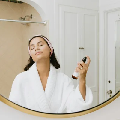 Hand reaching for skincare jars